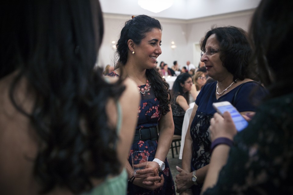 Anna Irani, 29, greets a friend at a Nowruz event hosted by the Zoroastrian Association of Metropolitan Washington at Kamran Dar-e Mehr in March of 2016. Emily Jan/Atlantic