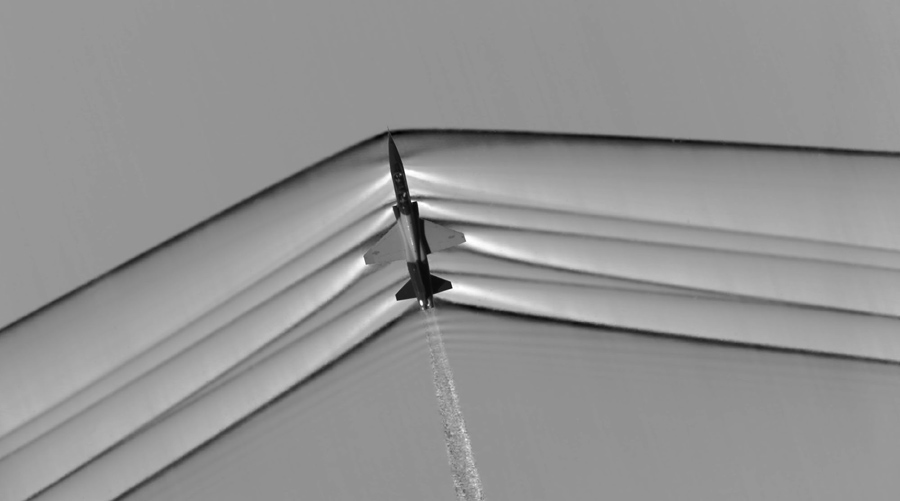 The shock wave of a T-38C supersonic jet flying over the Mojave Desert in California is seen in this NASA schlieren image released on August 25, 2015.