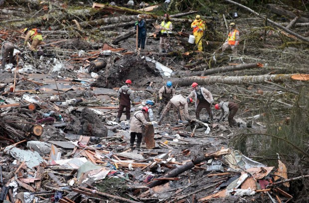 Workers sift through a deadly landslide last March in Oso, Washington. (Lindsey Wasson/AP)