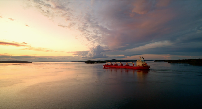 Cargo ship in beautiful waters of coastal Maine, at sunset.