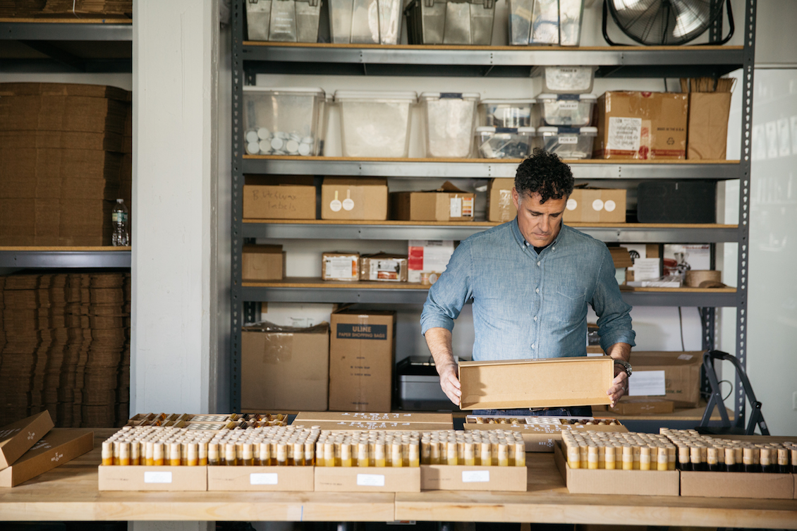 Zeke Freeman, owner and founder of Bee Raw Honey, packaging raw honey tasting kits.