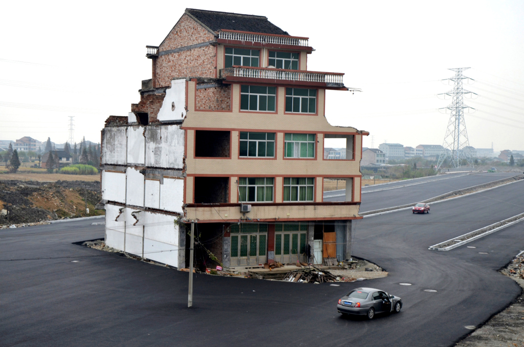 In late 2012, an elderly couple refused to sign an agreement to allow their house to be demolished. Their home was the only building left standing on a paved road through their village.
