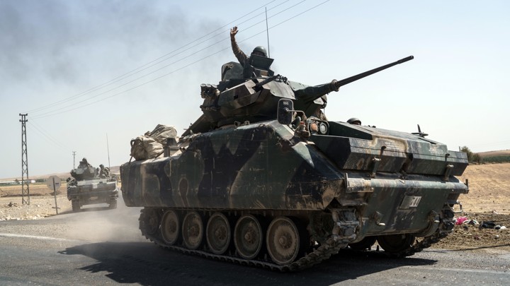 Turkish troops head to the Syrian border, in Karkamis, Turkey, on August 27.