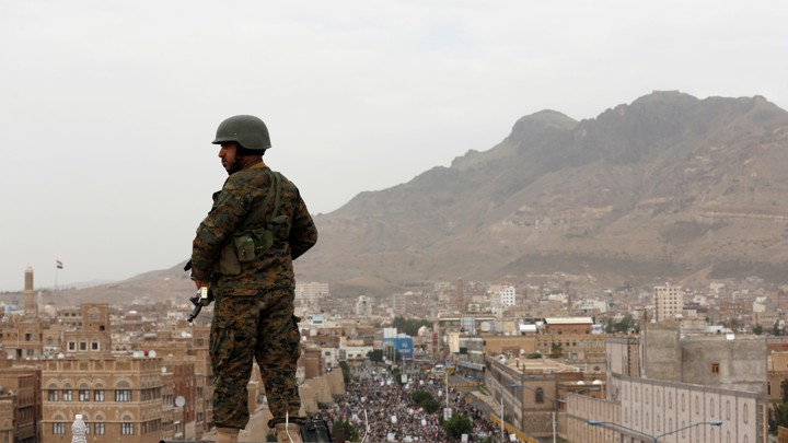 A Houthi soldier overlooking demonstrations in Sanaa, Yemen.