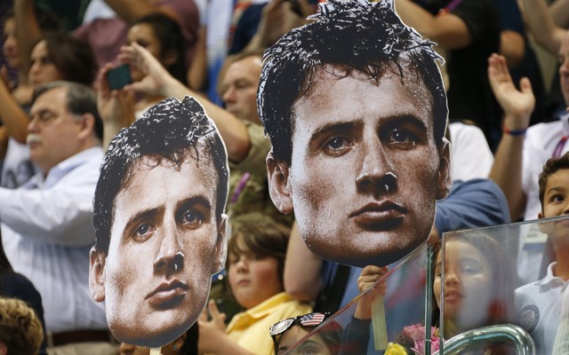 Fans at the 2012 London Olympics hold cutouts of U.S. Olympic swimmer Ryan Lochte.