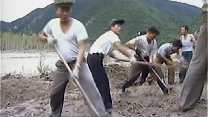 Workers build levees along a river bank in North Korea, where flooding has caused significant damage in the country's north-eastern province.