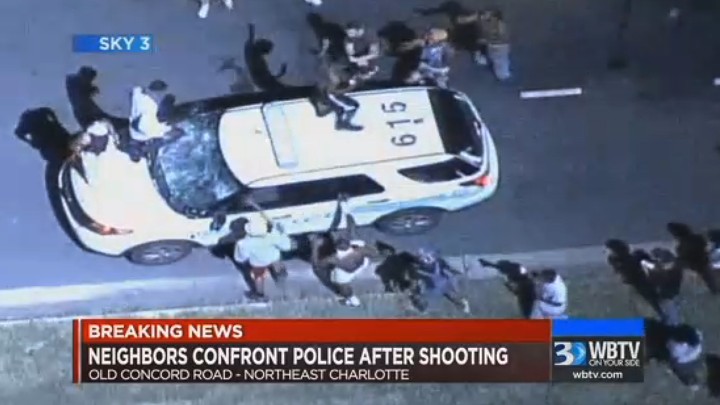A police vehicle is damaged after protests broke out Tuesday in Charlotte, North Carolina, following a fatal shooting of a black man by police.