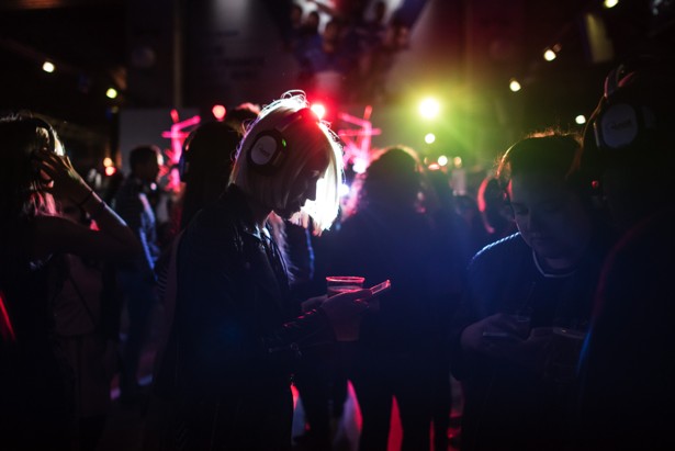 A woman looks at her phone as she takes part in a silent disco.