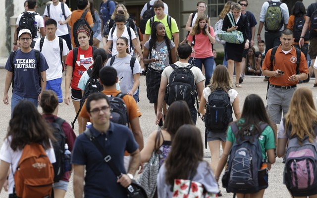 Students walk around with backpacks.