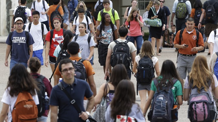 Students walk around with backpacks.