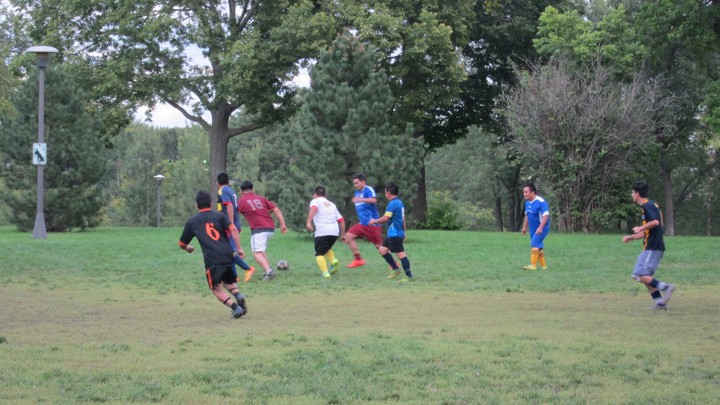 Ecuadorian immigrants play soccer in Powderhorn Park in Minneapolis.
