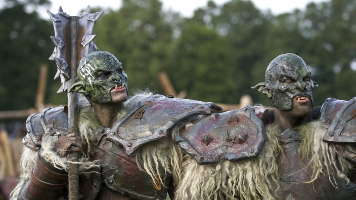 Two tall men in armor and troll costumes stand outside in Germany.