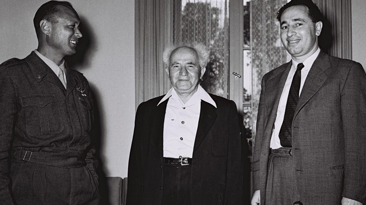 David Ben-Gurion, center, then Israel's defense minister, stands with Moshe Dayan, the military's Chief of Staff, left, Shimon Peres, the director general of the Ministry of Defense in Tel Aviv on February 2, 1955.