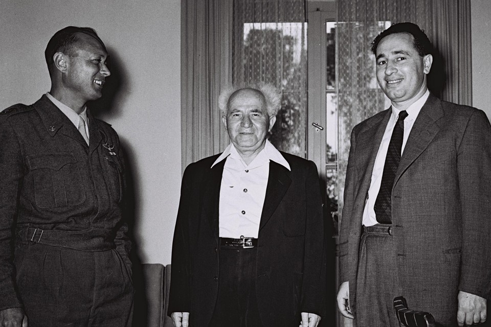 David Ben-Gurion, center, then Israel's defense minister, stands with Moshe Dayan, the military's Chief of Staff, left, Shimon Peres, the director general of the Ministry of Defense in Tel Aviv on February 2, 1955. 