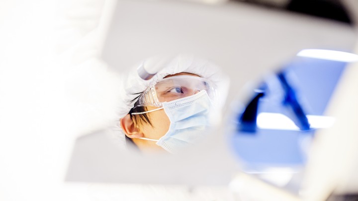 A researcher measures a film on a silicon wafer at UC Berkeley's Marvell Nanofabrication Laboratory, which is used to develop nanometer-scale materials.