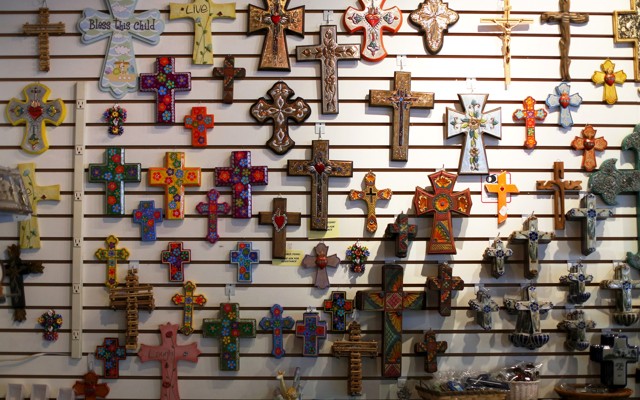 Colorful crucifixes decorate a gift shop wall.