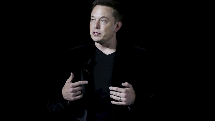 Elon Musk speaking at a presentation in 2015