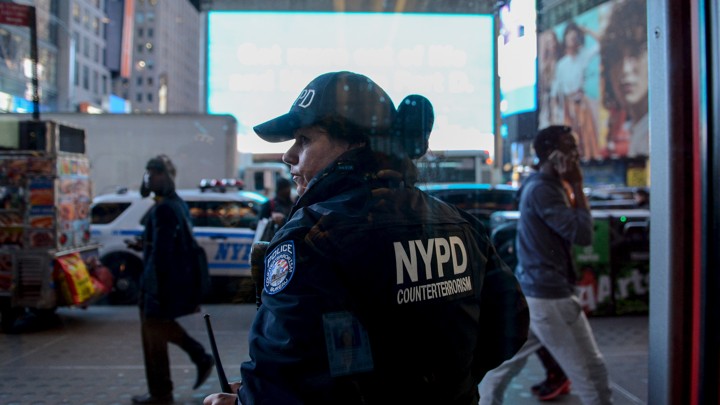 A NYPD counter-terrorism officer is seen through a window in New York City.
