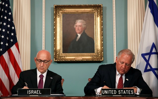 U.S. and Israeli officials sign an unprecedented military-spending deal in Washington, D.C. on September 14, surrounded by a portrait of Thomas Jefferson and American and Israeli flags.