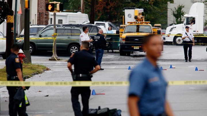 Law enforcement officers mark evidence near the site where Ahmad Khan Rahami, sought in connection with a bombing in New York, was taken into custody in Linden, New Jersey,