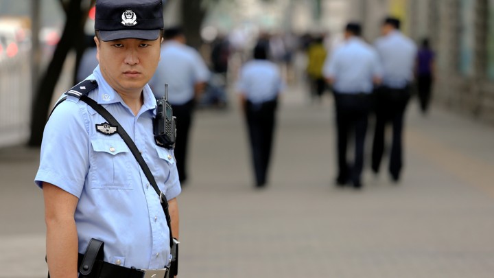 A policeman stands outside Beijing’s Number 2 People's Intermediate Court Thursday during Xia Lin sentence hearing.