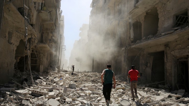Men inspect the damage after an airstrike on the rebel held al-Qaterji neighbourhood of Aleppo, Syria September 25, 2016.
