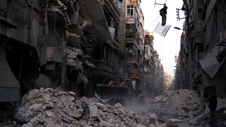 White Helmets sift through the rubble after an airstrike hits the rebel-held al-Shaar neighbourhood in Aleppo, Syria.