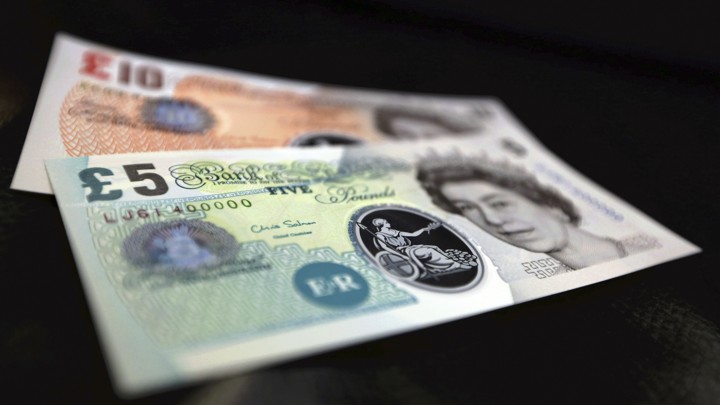 Sample plastic five and 10 pound notes on display at the Bank of England in London.