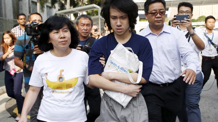 Teen blogger Amos Yee leaves with his parents after his sentencing from the State Court in Singapore July 6, 2015.