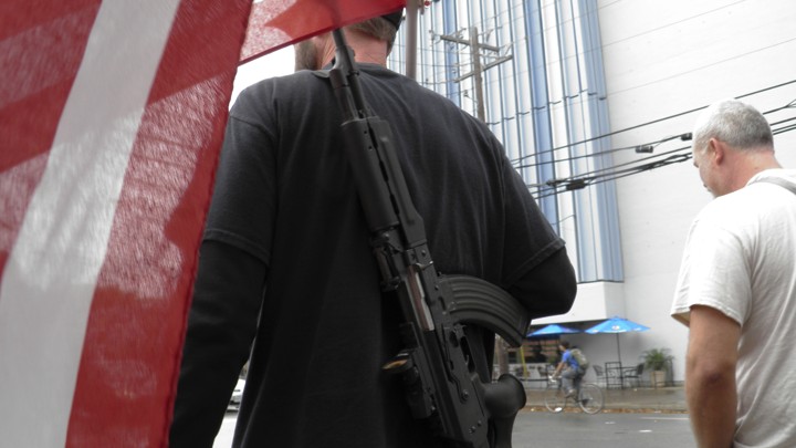 A man with a gun strapped to his back walks down the street near the University of Texas, as he and other pro-gun advocates prepare for a 'mock mass shooting’ in 2015. The demonstration was intended to show the need for firearms on campus.