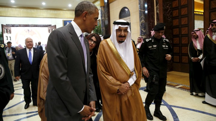 President Barack Obama walks with Saudi King Salman.