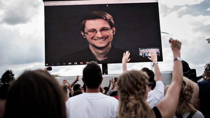 American whistleblower Edward Snowden is seen on a screen as he delivers a speech during the Roskilde Festival in Roskilde, Denmark, on June 28 2016.