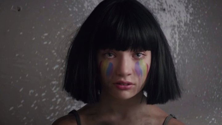 Maddie Ziegler wears rainbow makeup in the video for "The Greatest"