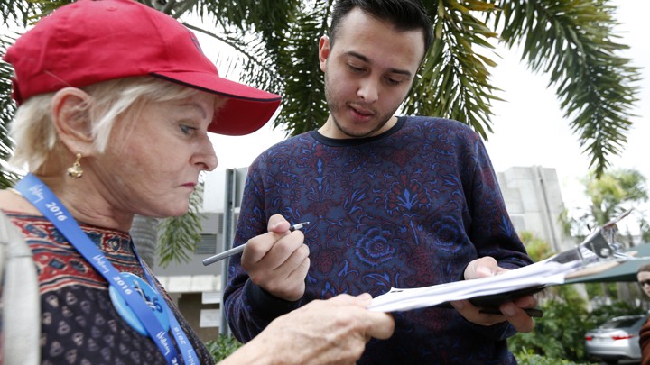 A Florida voter fills out a voter registration form in Miami, Florida, on October 11, 2016.