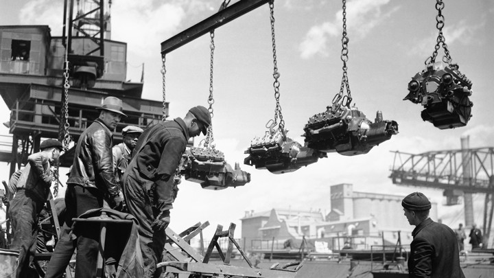 Workers unload finished engines at Ford’s River Rouge plant in 1937.