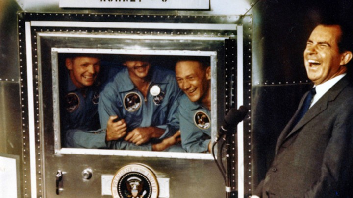 The Apollo XI astronauts Neil Armstrong, Michael Collins, and Buzz Aldrin laugh with President Richard Nixon aboard the USS Hornet in 1969.