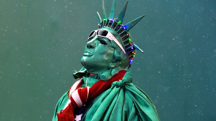 A street performer dressed as the Statue of Liberty stands amongst light snow in Times Square, in New York, in December 2014.