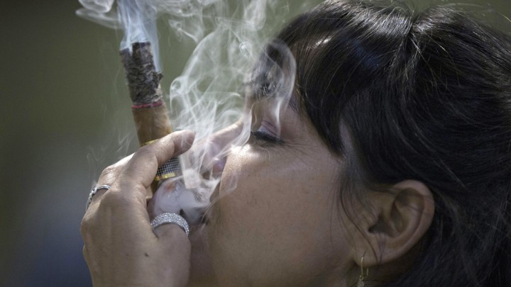 Cigar sommelier Ivonne de La Puente, 47, smokes a cigar during the XVII Habanos Festival in Havana, February 23, 2015.