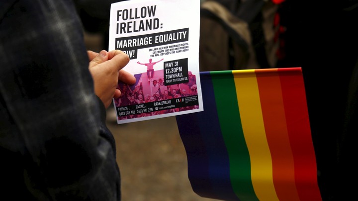 Activists hold signs in support of same-sex marriage in Australia.