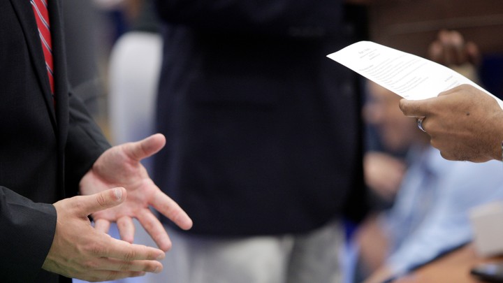 A job seeker discusses his resume with a recruiter.