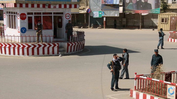 Afghan policemen keep watch in downtown Kunduz, Afghanistan, on Monday.