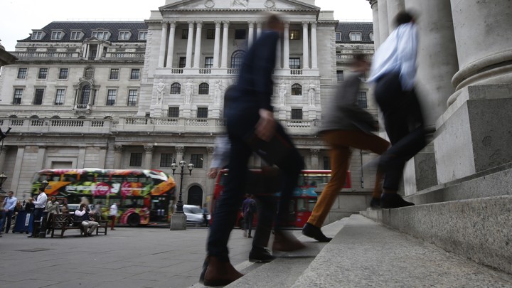 Pedestrians walk past the Bank of England