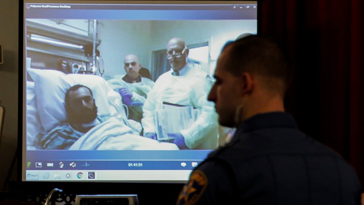 A NJ Union county Sheriff stands guard as he listens to the hearing of Ahmad Khan Rahimi in a court room.