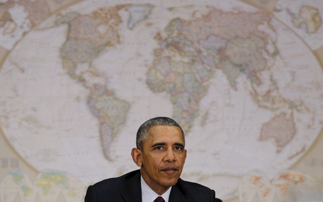 Sitting in front of a world map, U.S. President Barack Obama attends a meeting with the National Security Council at the State Department in Washington February 25, 2016. 