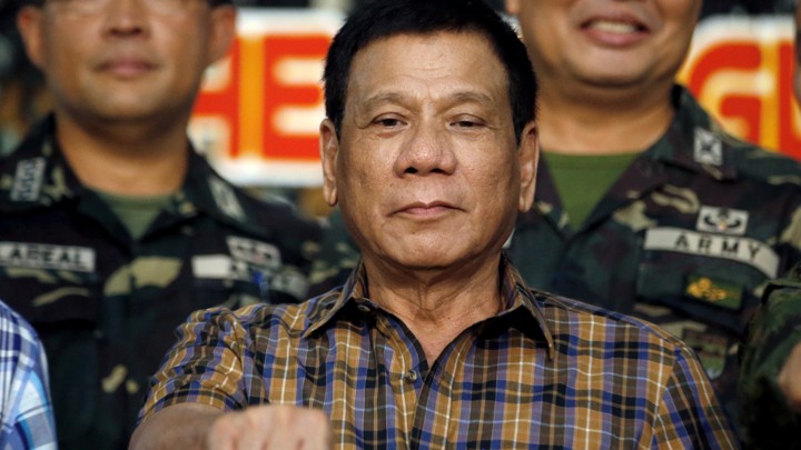 Philippine President Rodrigo Duterte makes a "fist bump", his May presidential elections campaign gesture, with soldiers during a visit at Capinpin military camp in Tanay, Rizal in the Philippines August 24