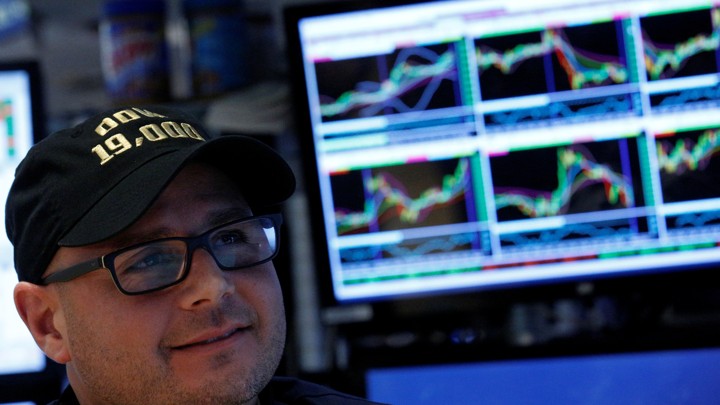 The specialist trader Mario Picone wears a Dow 19,000 hat on the floor of the New York Stock Exchange on November 22, 2016.