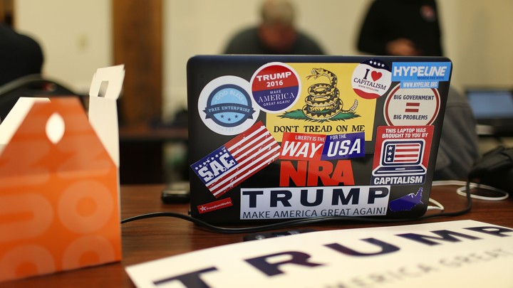A computer covered in pro-Trump stickers sits on a table at a campaign office in New Hampshire