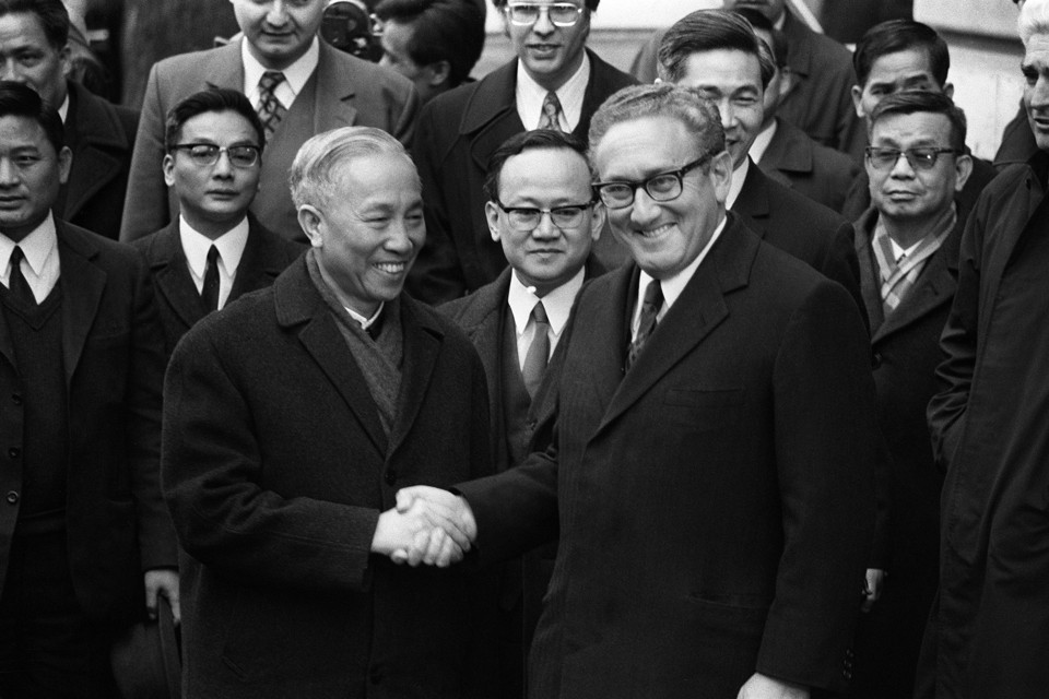 Henry Kissinger shakes hand with Le Duc Tho, leader of North Vietnam delegation, after the signing of the Paris Peace Accords on January 23, 1973.