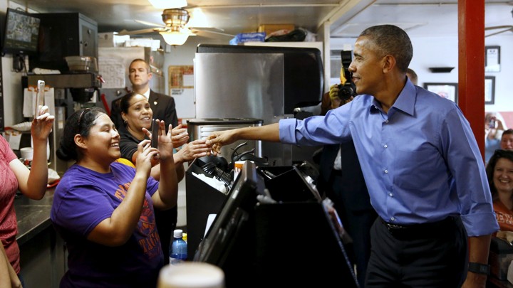 President Barack Obama shakes hands with restaurant employees