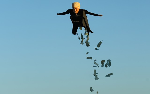 A remote-control plane resembling Donald Trump releases fake money as it flies over a beach in Southern California.